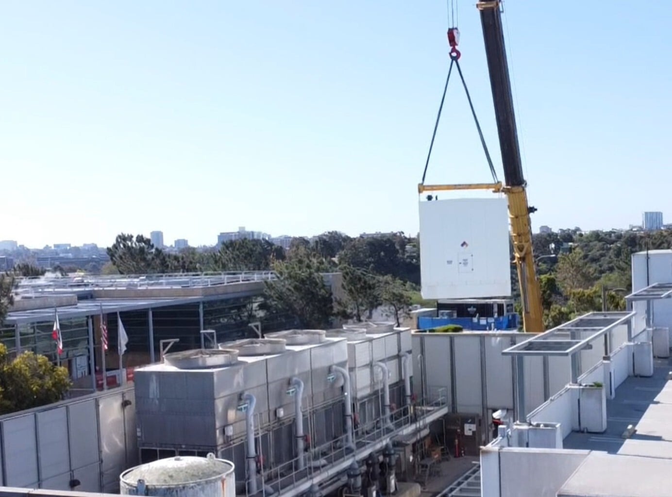 Laser Electric using cranes to load equipment on a job site