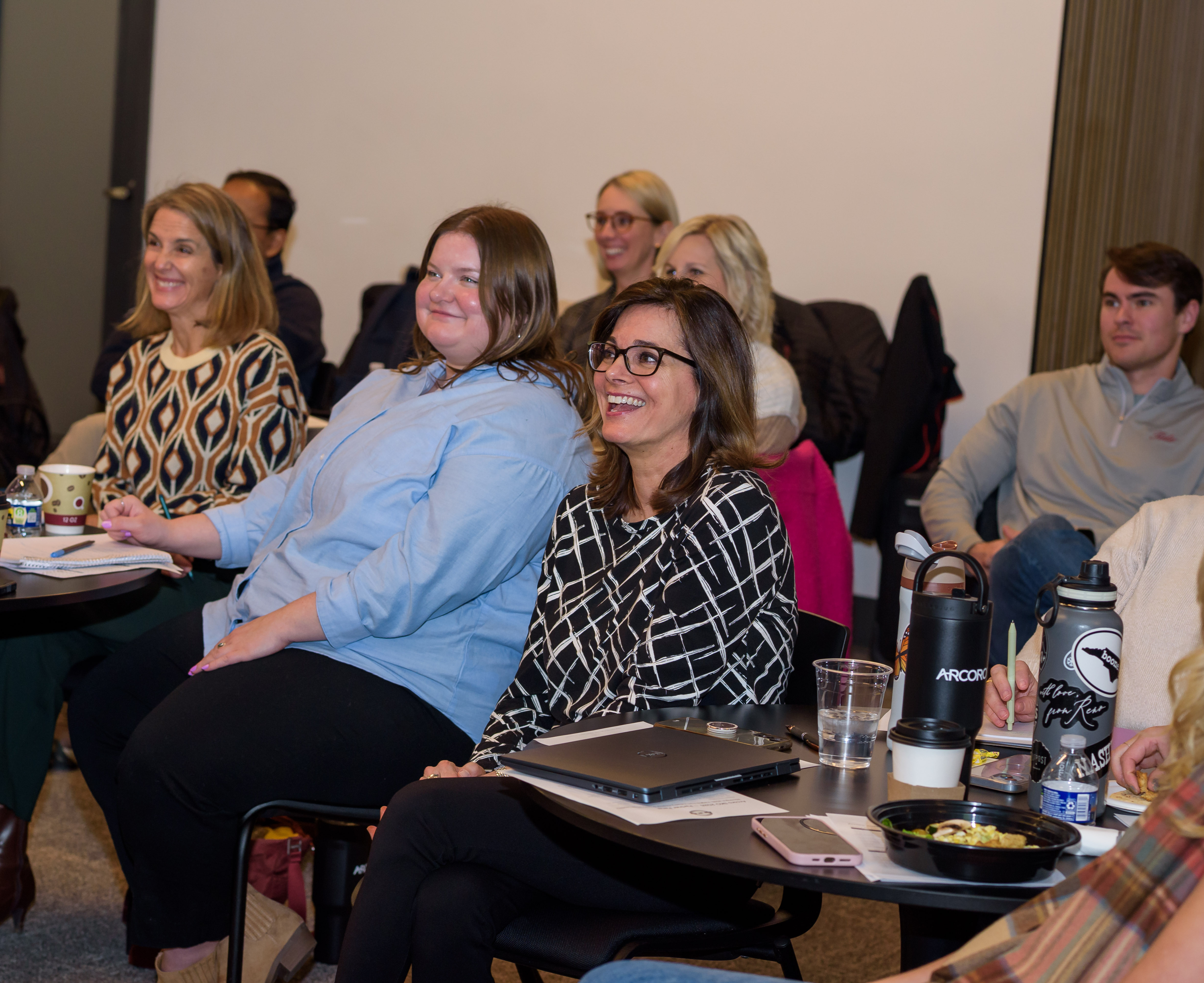 Group of employees smiling in a conference room